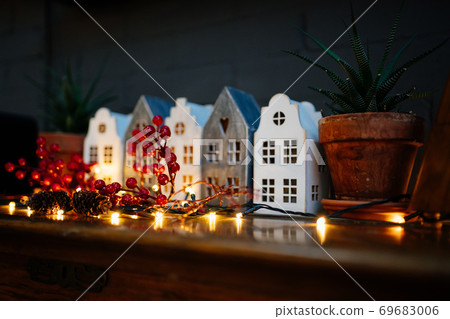 Christmas. miniature houses and sprig of Rowan 69683006