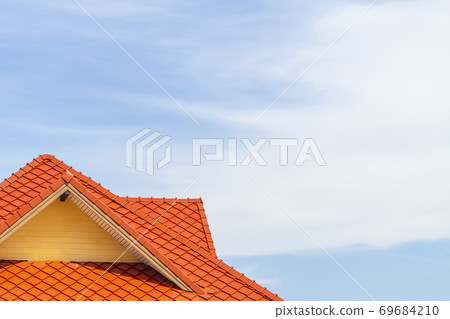 Orange tile roof with a blue sky background and 69684210