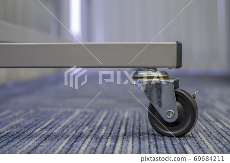 Small black rubber wheel on the carpet.Office 69684211