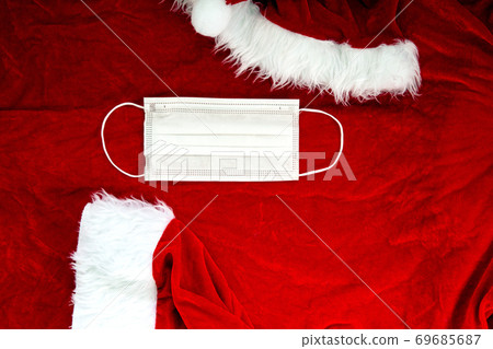 Santa Claus red hat with medical face mask on Santa Claus suit Fabric, Covid-19 and Christmas concept, background texture Santa Claus red hat with medical face mask on Santa Claus suit Fabric, Covid-19 and Christmas concept, background texture 69685687