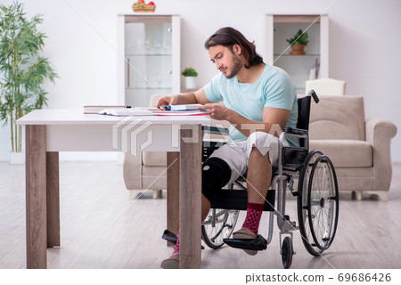 Young student in wheel-chair studying at home 69686426