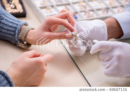 Male jeweler and female client at store Male jeweler and female client at store 69687138