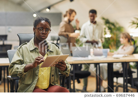 African-American Woman Posing with Tablet in Office 69687446