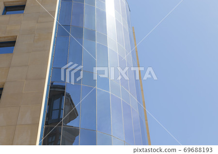 The facade of the building of glass and concrete. Sun reflection 69688193