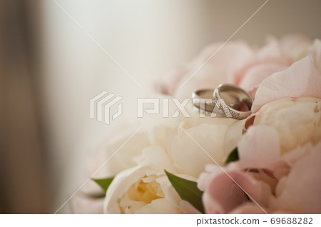 Two wedding rings on a delicate wedding bouquet Two wedding rings on a delicate wedding bouquet 69688282