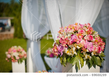 Wedding arch. The idea of decorating the wedding area with flowers 69688289