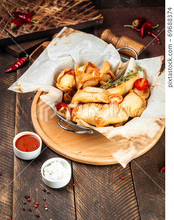 Russian snacks mini fried pies chebureki wth sauce Russian snacks mini fried pies chebureki wth sauce 69688374