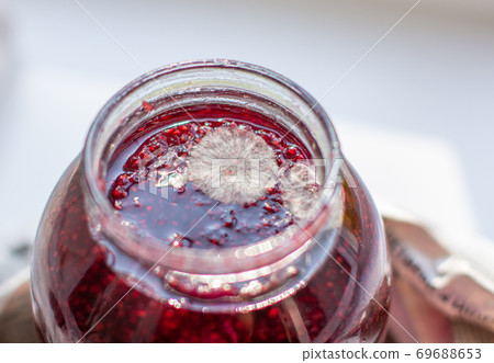 Mold in a jar of raspberry jam. Hazardous to health.  69688653