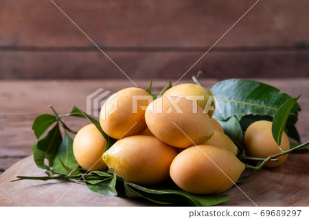 Heap of Thai plango fruit or marian plum on wood plate 69689297