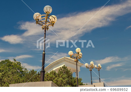 Street lights in Chernomorsk city, Ukraine, colonnade in the background. 69689932