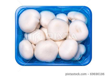 Fresh champignon mushrooms in a plastic container isolated on white 69690186