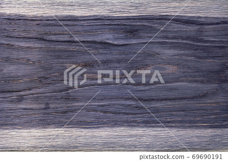 The texture of a wooden board painted in purple. Empty background. The texture of a wooden board painted in purple. Empty background. 69690191