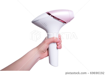 The girl holds a photoepilator in her hand. A device for removing unwanted hair isolated on white. 69690192