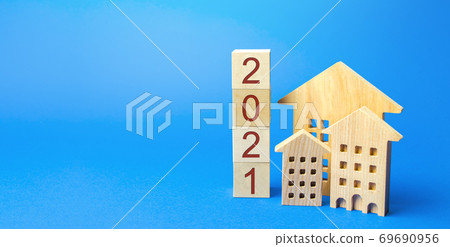 2021 wooden blocks and miniature house. Real estate concept. Family budget planning. Investments, plans, savings. Mortgage and mortgage rates. Forecasts. Loan. Refinance home 2021 wooden blocks and miniature house. Real estate concept. Family budget planning. Investments, plans, savings. Mortgage and mortgage rates. Forecasts. Loan. Refinance home 69690956