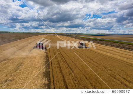 Aerial view of combine on harvest field Aerial view of combine on harvest field 69690977