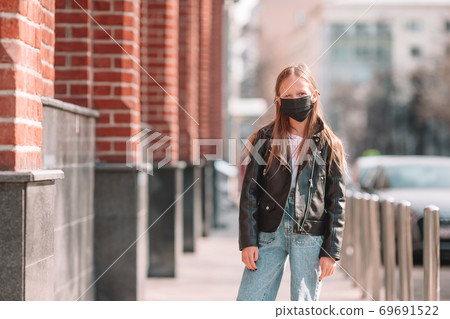 Girl wearing a mask protect against Coronavirus and gripp Girl wearing a mask protect against Coronavirus and gripp 69691522