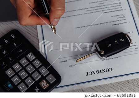 Close up shots hands of client signing car lease form 69691881