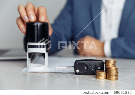 Car salesman stamping contract, concept for sale car, insurance with car, moving car or renting car Car salesman stamping contract, concept for sale car, insurance with car, moving car or renting car 69691883