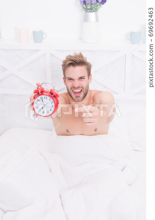 Look at this clock. Stressful man point finger at clock face 69692463