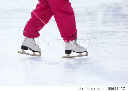 feet skating on the ice rink 69693437