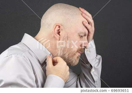 man in the shirt thinks holding his hands behind his head man in the shirt thinks holding his hands behind his head 69693651