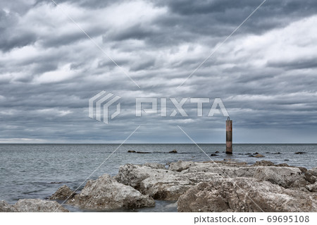 A cloudy day in front of the sea A cloudy day in front of the sea 69695108