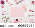 Pink blank paper on fashion feminine desk top view 69695134