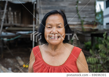 slow-motion of Thai elderly woman in round-necked sleeveless collar laughing in wooden home slow-motion of Thai elderly woman in round-necked sleeveless collar laughing in wooden home 69696301