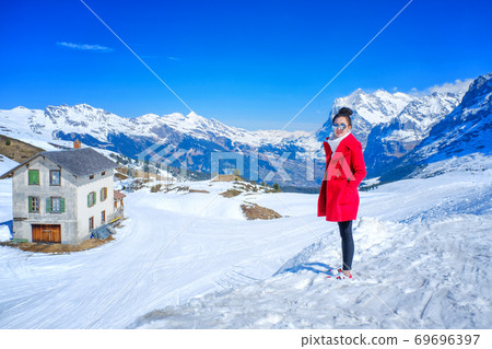 Young Woman Tourists see beautiful viewpoitn near Kleine Scheidegg station In daylight atI Switzerland 69696397