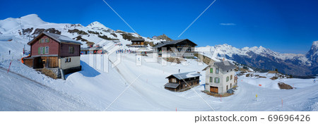 Panoramic view from Kleine Scheidegg station, along the railway from Interlaken to Jungfraujoch (3,466 m). In daylight at Switzerland Panoramic view from Kleine Scheidegg station, along the railway from Interlaken to Jungfraujoch (3,466 m). In daylight at Switzerland 69696426