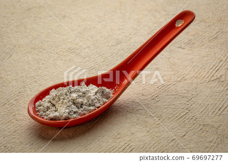 food grade diatomaceous earth supplement on a spoon food grade diatomaceous earth supplement on a spoon 69697277