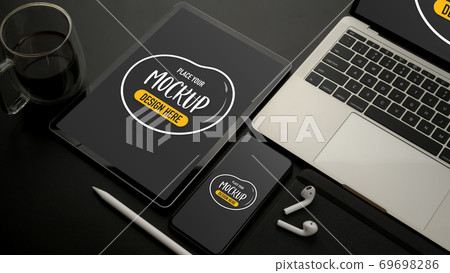 Mock up digital devices with tablet, smartphone, laptop and accessories on black desk 69698286