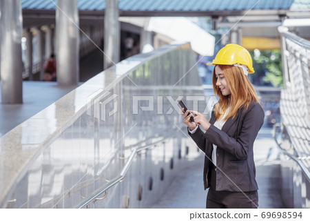 Construction engineer in Safety Suit Trust Team Holding White Yellow Safety hard hat Construction engineer in Safety Suit Trust Team Holding White Yellow Safety hard hat 69698594