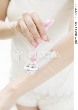 Woman doing unwanted hair processing Woman doing unwanted hair processing 69699486