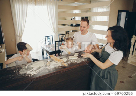 the family makes cakes. the children were covered in flour. dinner at the bakery. feast in the kitchen. mother's little helpers the family makes cakes. the children were covered in flour. dinner at the bakery. feast in the kitchen. mother's little helpers 69700296