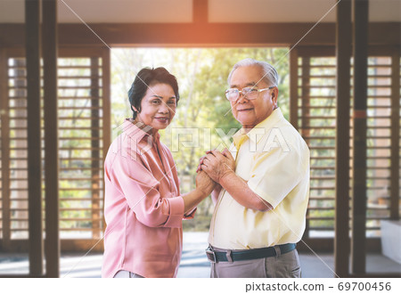 Senior Asian couple holding hands for love and togetherness conc Senior Asian couple holding hands for love and togetherness conc 69700456