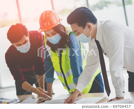 Construction team with business man engineer and architect is di Construction team with business man engineer and architect is di 69700457