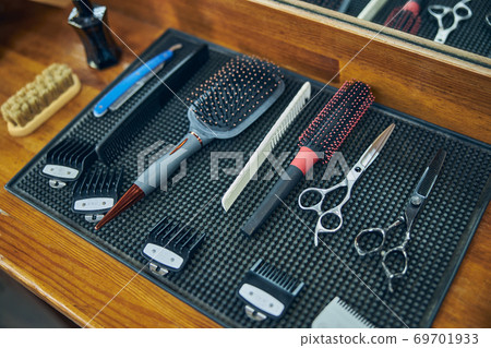 HIgh-quality barbering equipment setup on a table in a barbershop HIgh-quality barbering equipment setup on a table in a barbershop 69701933