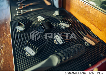 Black hair clipper guards laying on a table 69701937
