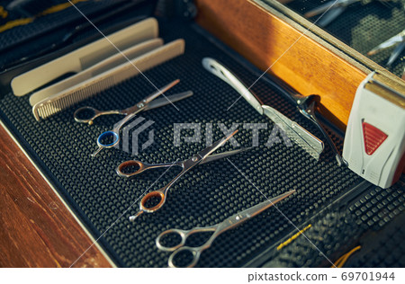 Neat set-up of professional tools in a barbershop Neat set-up of professional tools in a barbershop 69701944