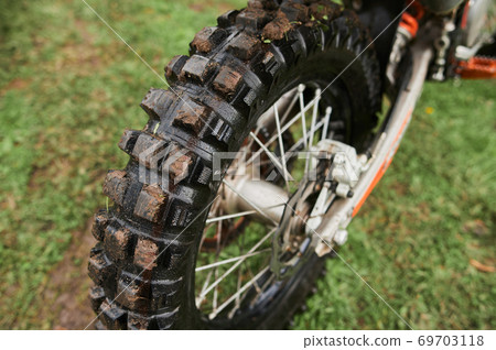 Close up of muddy rear wheel of dirt bike Stock Photo