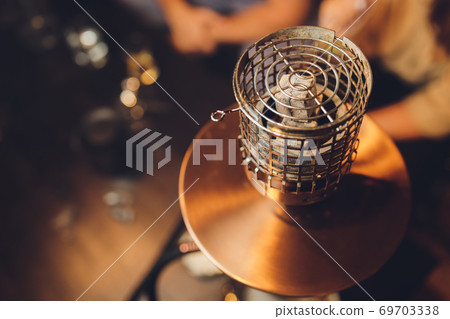 Shisha hookah with red hot coals. Sparks from breathe. Modern hookah with coconut charcoal and shisha smoke. Hookah and sparks from coals.,traditional hookah hot coals for smoking natural lighting. 69703338