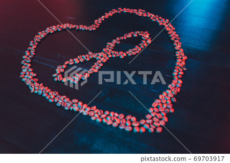 Valentine's Day concept, polyamory symbol heart and infinity sign in the middle. coffee beans. Valentine's Day concept, polyamory symbol heart and infinity sign in the middle. coffee beans. 69703917