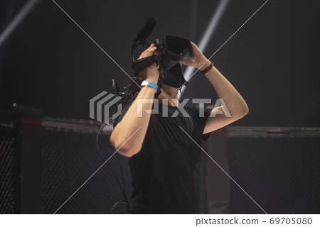 cameraman on the set of the ultimate fighting show. cameraman on the set of the ultimate fighting show. 69705080