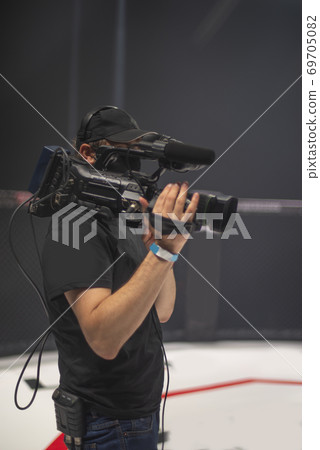 cameraman on the set of the ultimate fighting show. cameraman on the set of the ultimate fighting show. 69705082