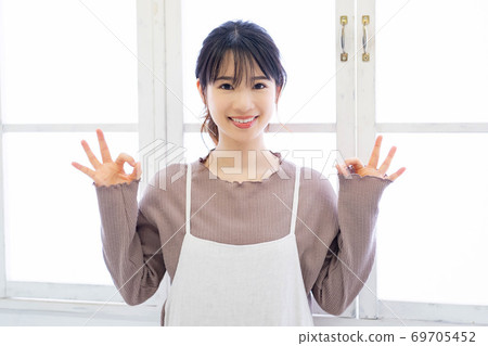 Young woman making an OK gesture Young woman making an OK gesture 69705452