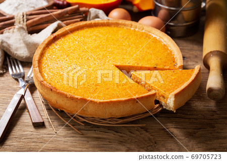 Pumpkin pie with ingredients for cooking Pumpkin pie with ingredients for cooking 69705723