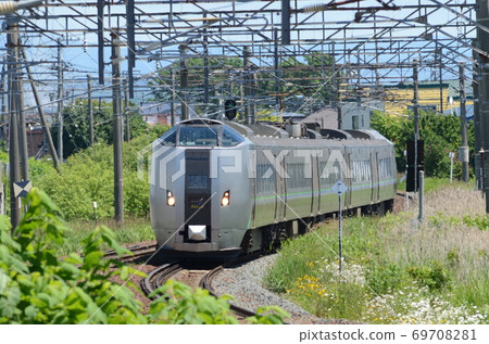 Limited express "Kamui" that runs through the residential area of Ebetsu city in the summer sun Limited express "Kamui" that runs through the residential area of Ebetsu city in the summer sun 69708281