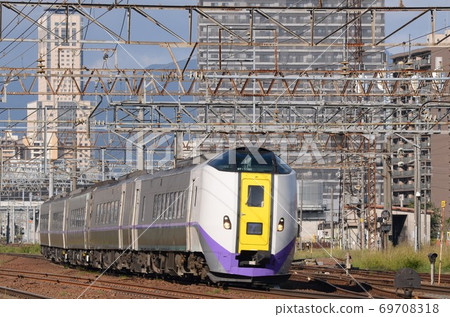 Limited express "Tokachi" heading to Obihiro with the JR Tower at Sapporo Station in the background 69708318