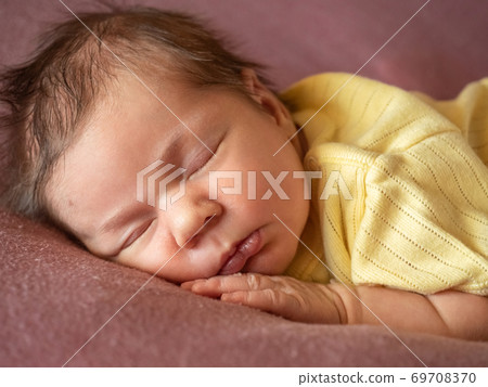 Portrait of 8 days old newborn baby girl sleeping Portrait of 8 days old newborn baby girl sleeping 69708370